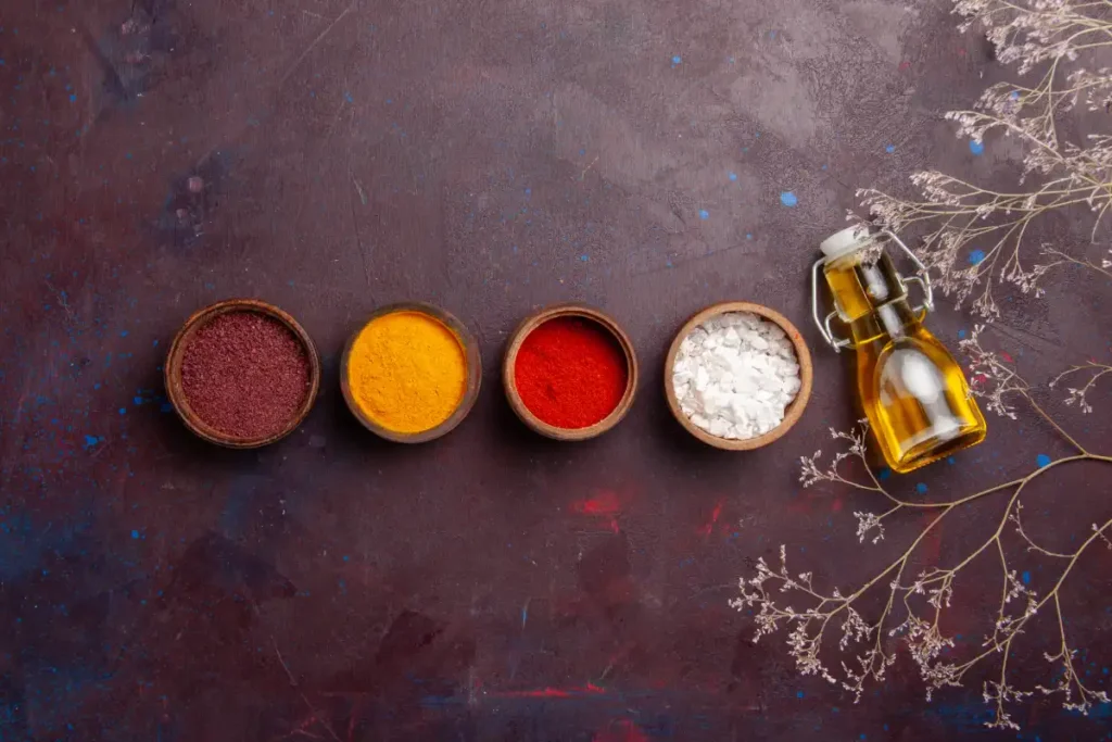 top view different seasonings with olive oil dark space